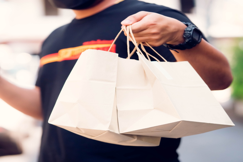 man ordering groceries online holding eco shopping bag banner background.supermarket grocery delivery online food and grocery in store.Mock-up shopping bag, business marketing.banner website.delivery.